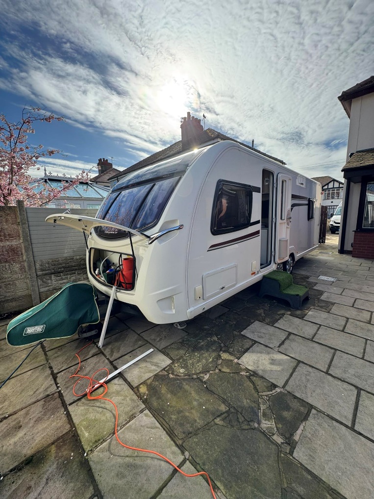 Caravan being serviced outdoors